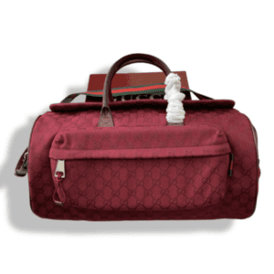 Upgrade your style with the Replica Medium GG Duffle Bag in Rosso Ancora red. Featuring iconic Gucci craftsmanship, this canvas bag is perfect for stylish, organized travel.