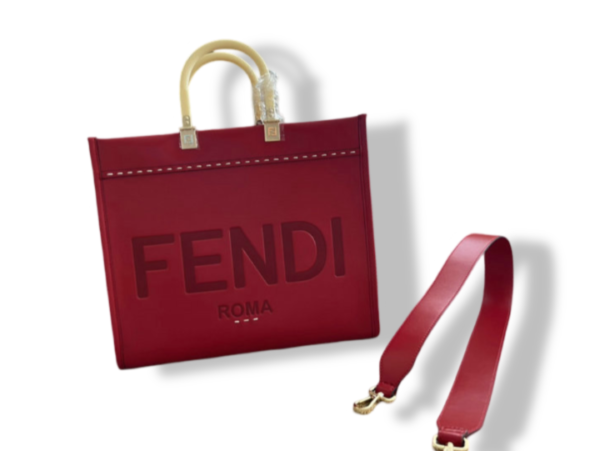 Discover the luxurious Fendi Sunshine Medium Shopper in Red Mirror 1:1 Replica. Crafted from premium dove-red leather with tortoiseshell handles and embossed Fendi Roma lettering, this versatile tote is perfect for any occasion.